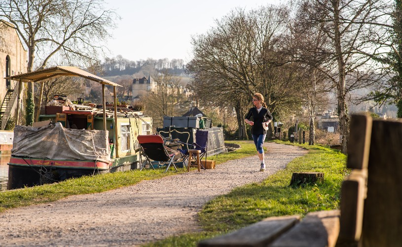 Person running along the Kennet and Avon Canal